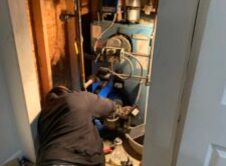 worker fixing a water heater installation