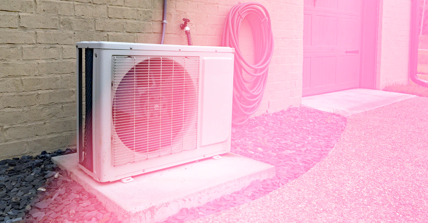 white hvac box outside of a beige house with a grey garage door 1